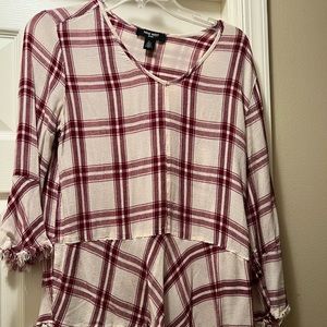Fun plaid top with bell fringe sleeves.